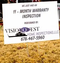 A home inspection sign in front of a house.